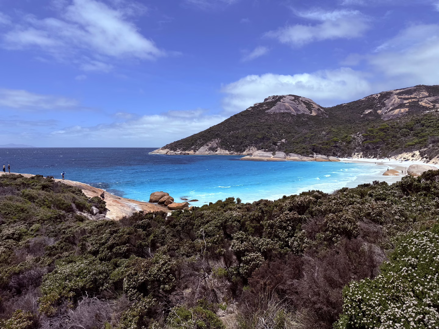 A picture of the crescent shaped beach, with pristine blue water