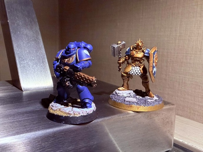 My partner painted a Stormcast Eternal Liberator, and I made the Space Marine, I gave it a heart on one shoulder pad, and a roman numeral 5 on the other, for 5 years.